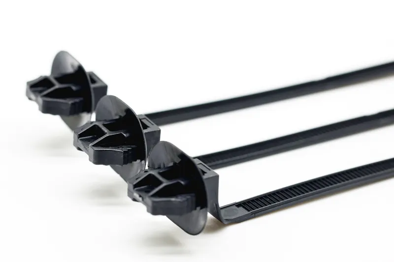 Automotive wiring harness fixing - square hole cable tie application in vehicle interior